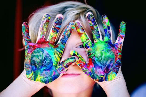 face with colourful hands