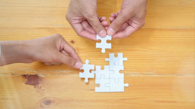 Person holding jigsaw